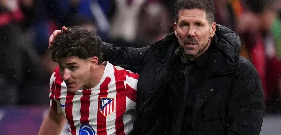 Atletico Madrid coach assisting player off field