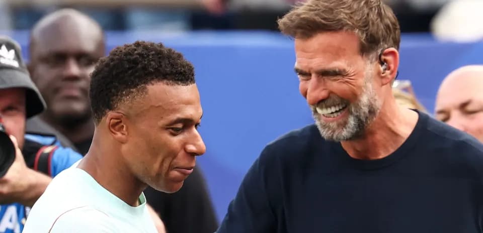 Kylian Mbappé and coach smiling during event