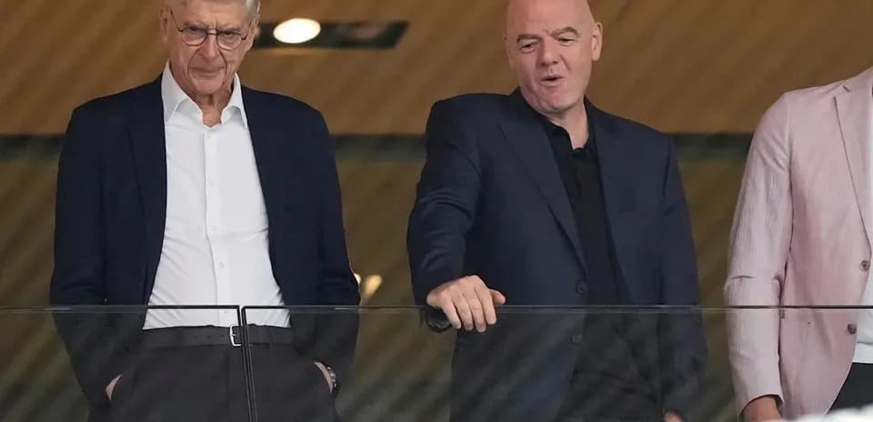 Two officials observing an event from a balcony