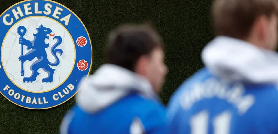 Chelsea FC emblem with players in training gear