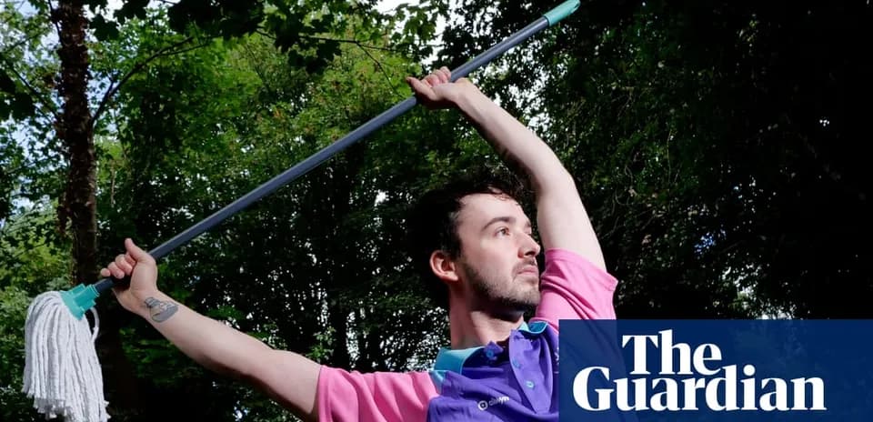 Person posing with a mop in outdoor setting