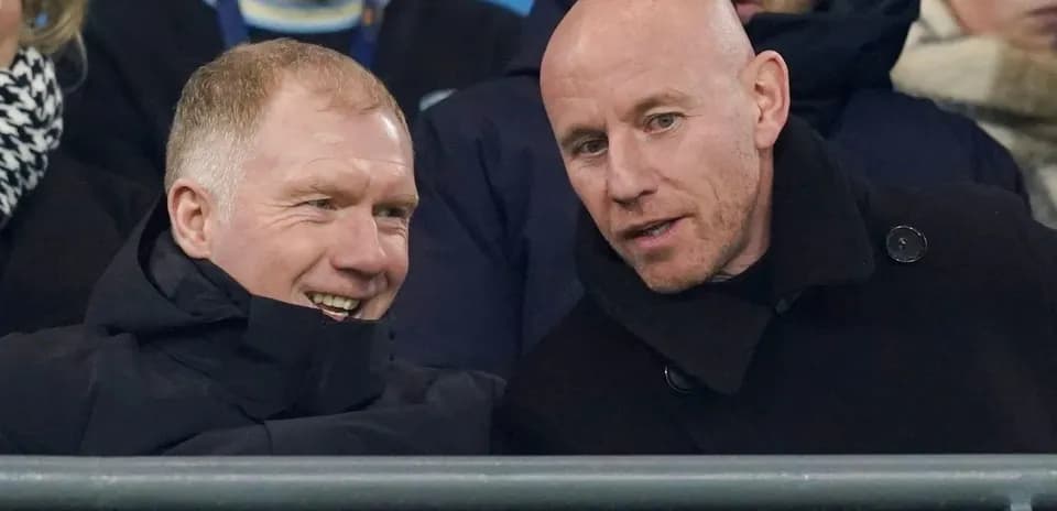 Two men conversing in stadium seating area