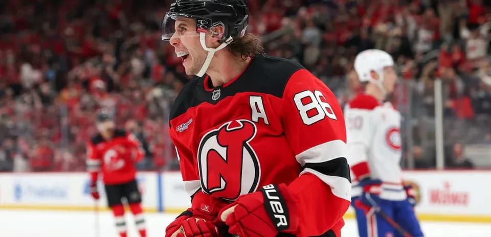 Hockey player celebrating goal in Devils jersey