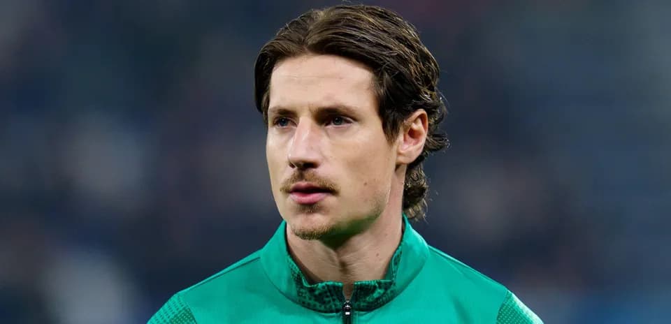 Football player in green training kit on field