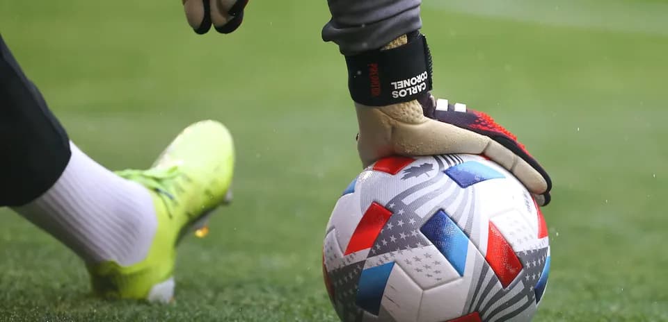 Goalkeeper placing ball on the field before kick