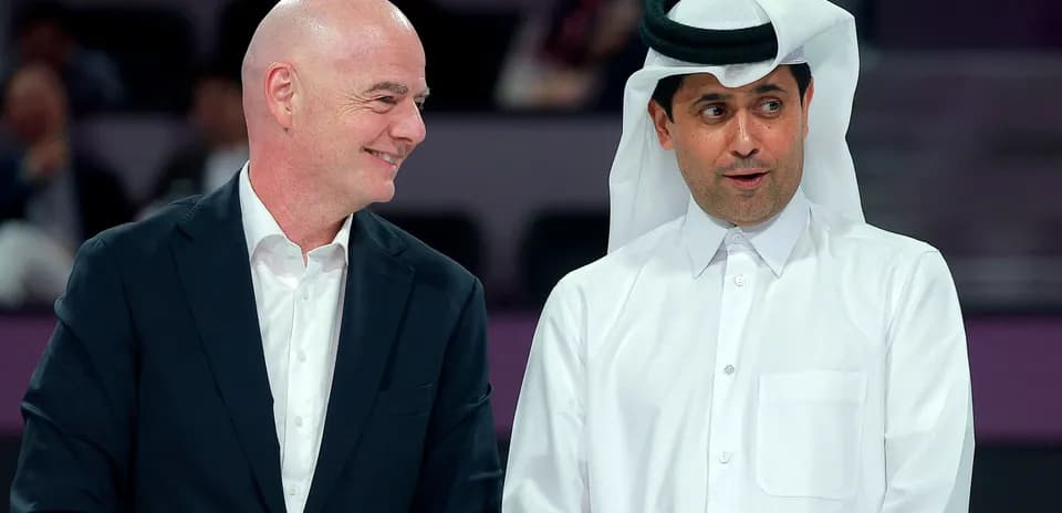 Two men talking at an event in Qatar