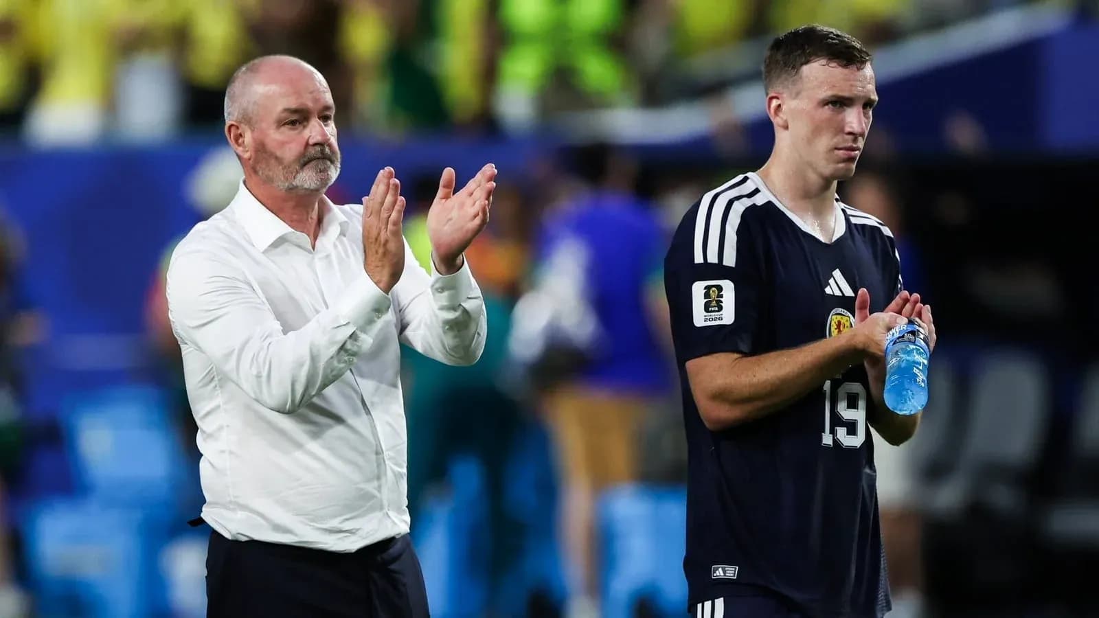 Coach and player applauding after match conclusion