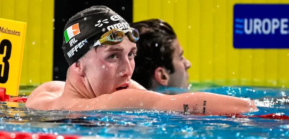 Swimmer resting in pool after a race
