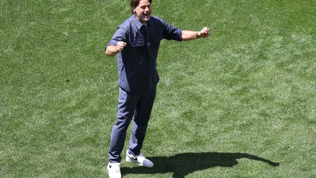 Coach celebrating on the pitch during training session Coach celebrating on the pitch during training session