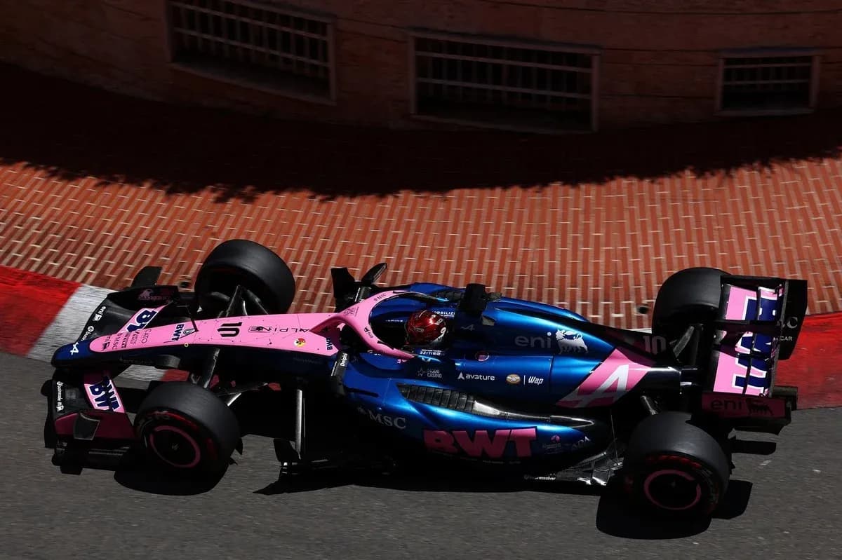 Formula 1 car racing around a corner on track Formula 1 car racing around a corner on track