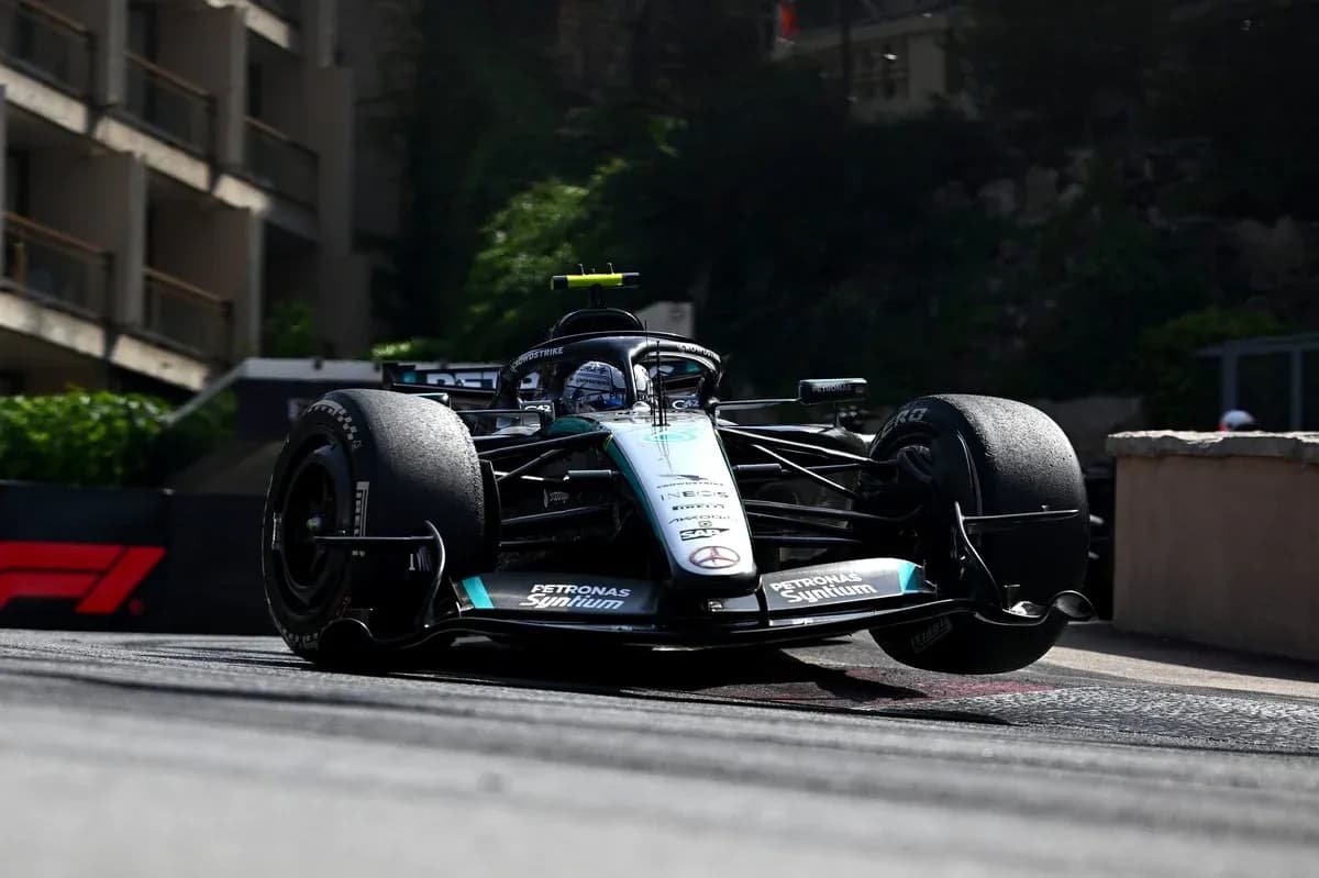 Formula 1 car racing around a corner on track Formula 1 car racing around a corner on track