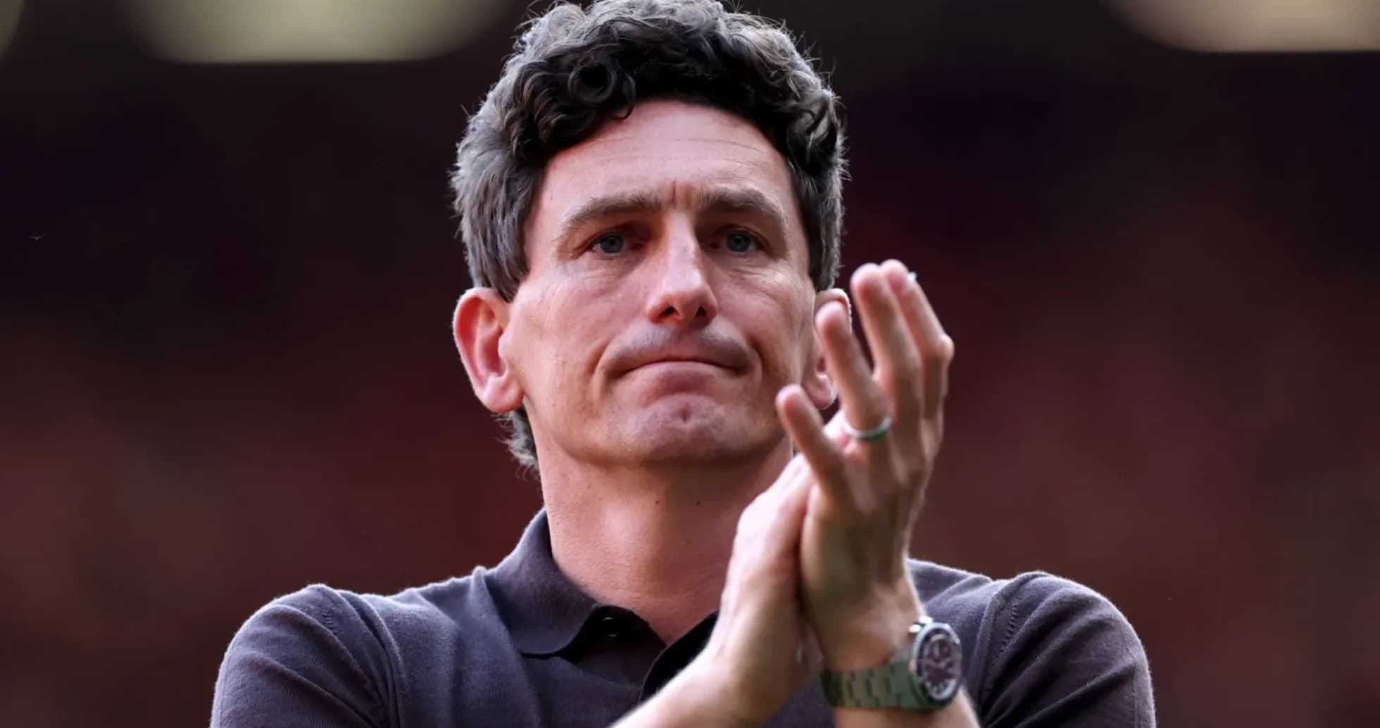 Men's football coach applauding in stadium Men's football coach applauding in stadium