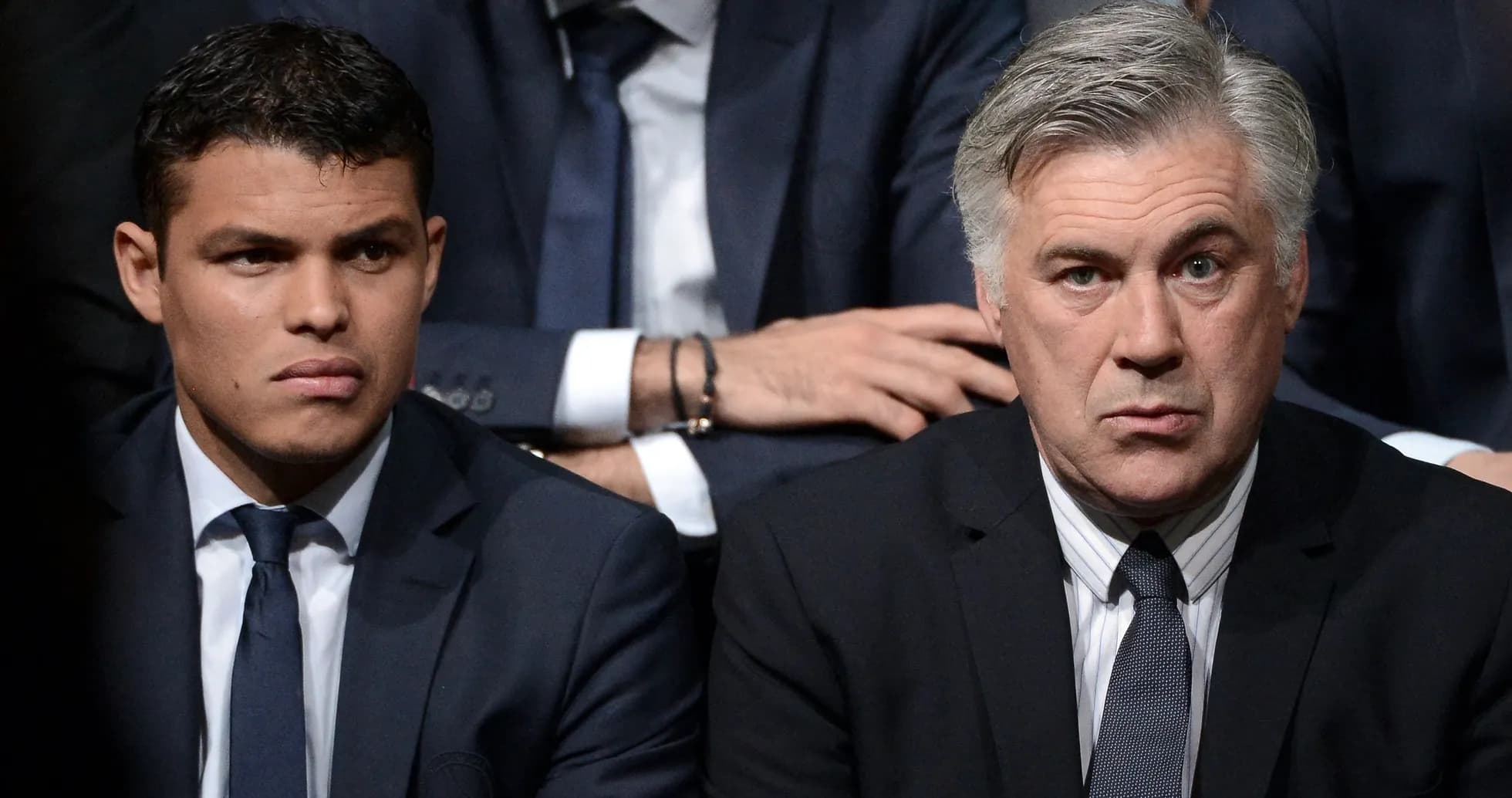 Two men seated in formal attire during event Two men seated in formal attire during event