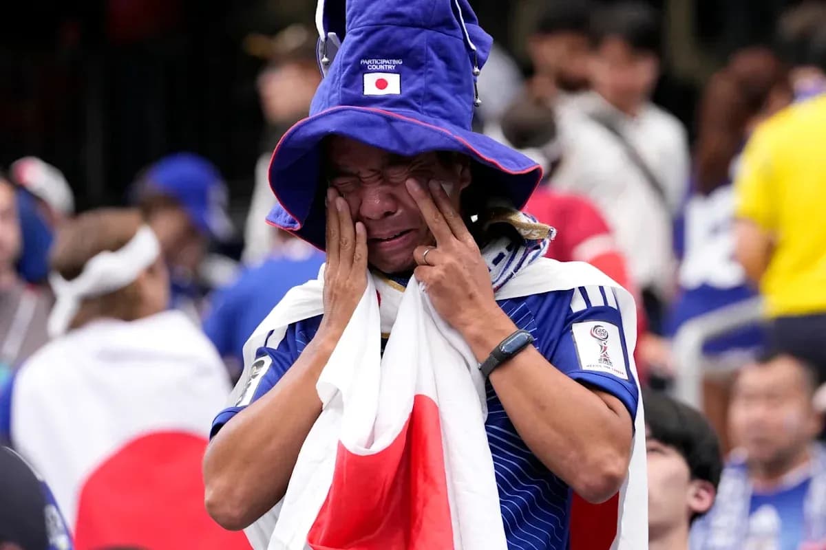 Japan fan in tears wearing national colors at event Japan fan in tears wearing national colors at event