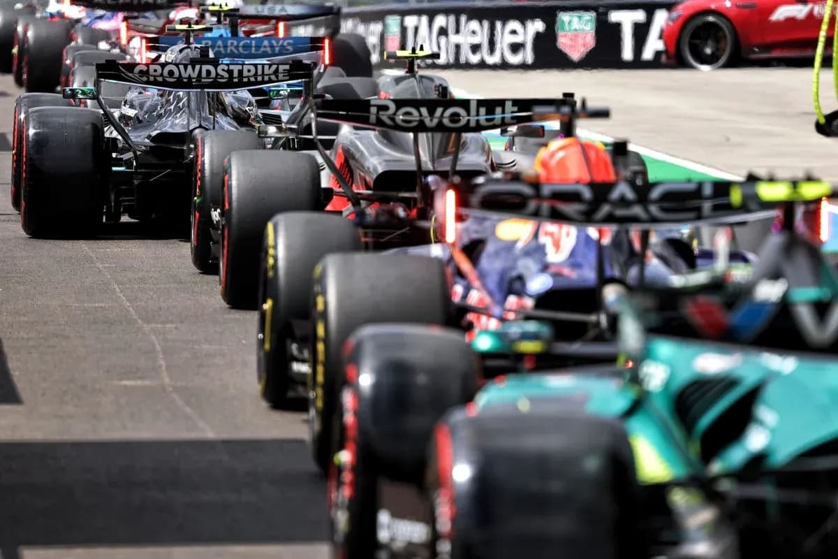Formula 1 cars lined up in the pit lane Formula 1 cars lined up in the pit lane