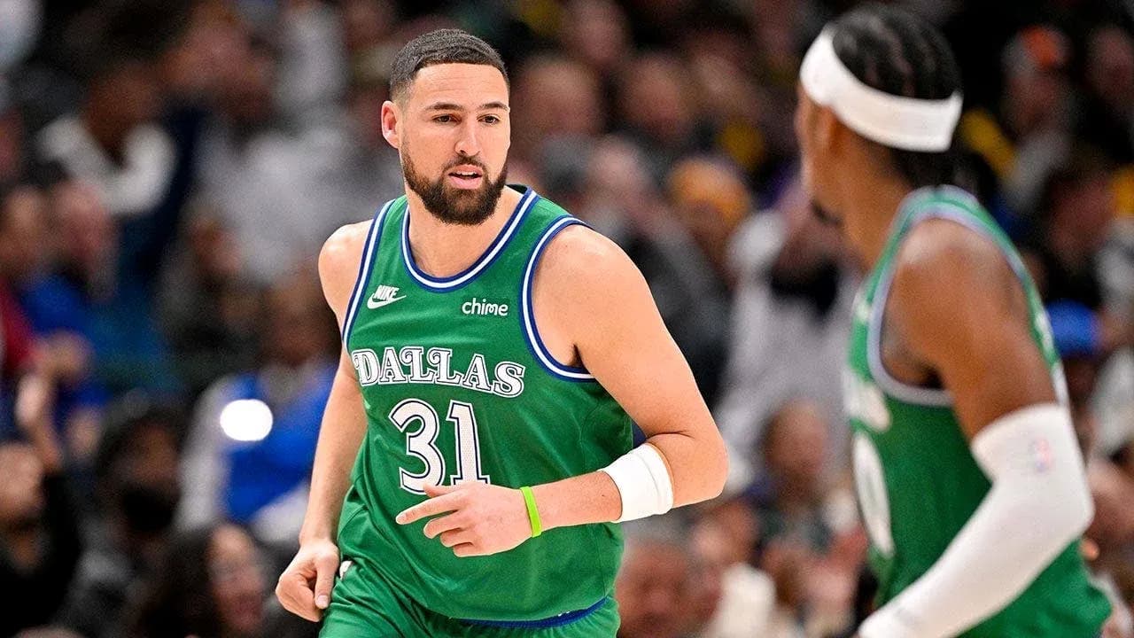Basketball player in Dallas Mavericks jersey on court Basketball player in Dallas Mavericks jersey on court