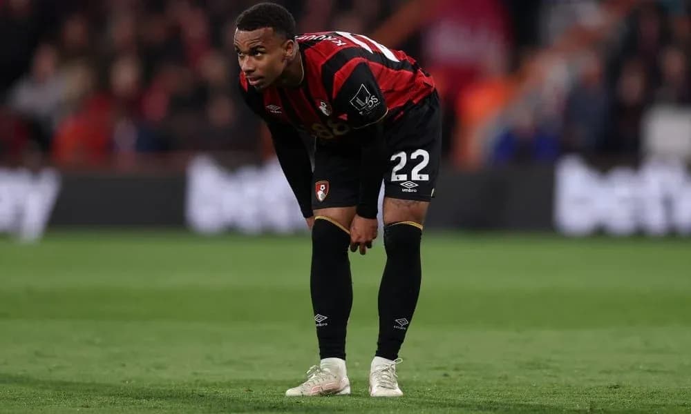 AFC Bournemouth player bending down on the pitch AFC Bournemouth player bending down on the pitch
