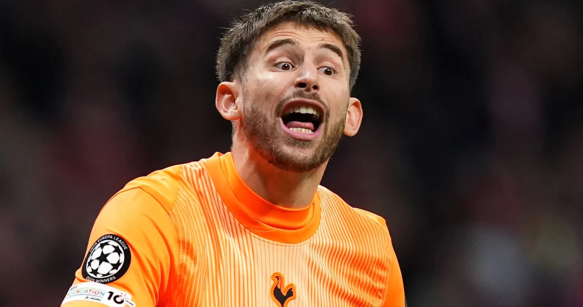 Goalkeeper shouting during a match in orange kit Goalkeeper shouting during a match in orange kit