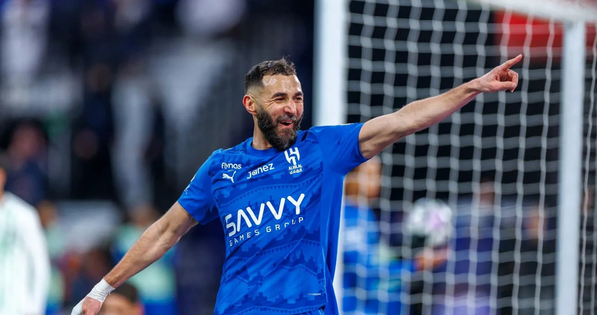 Futbolchi gol urganidan so'ng qo'lini ko'tarib turibdi Futbolchi gol urganidan so'ng qo'lini ko'tarib turibdi