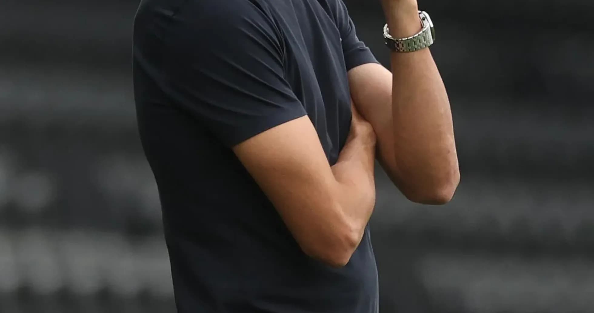 Coach observing the match with arms crossed Coach observing the match with arms crossed