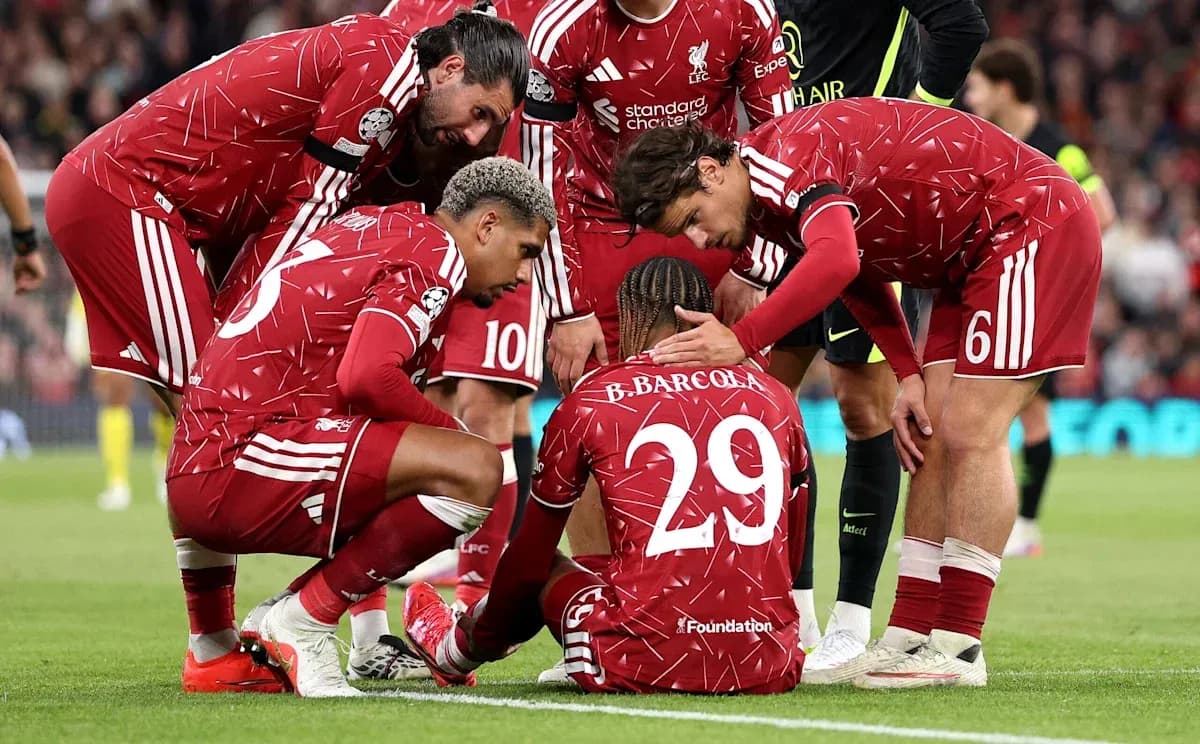 Liverpool players supporting injured teammate on field Liverpool players supporting injured teammate on field