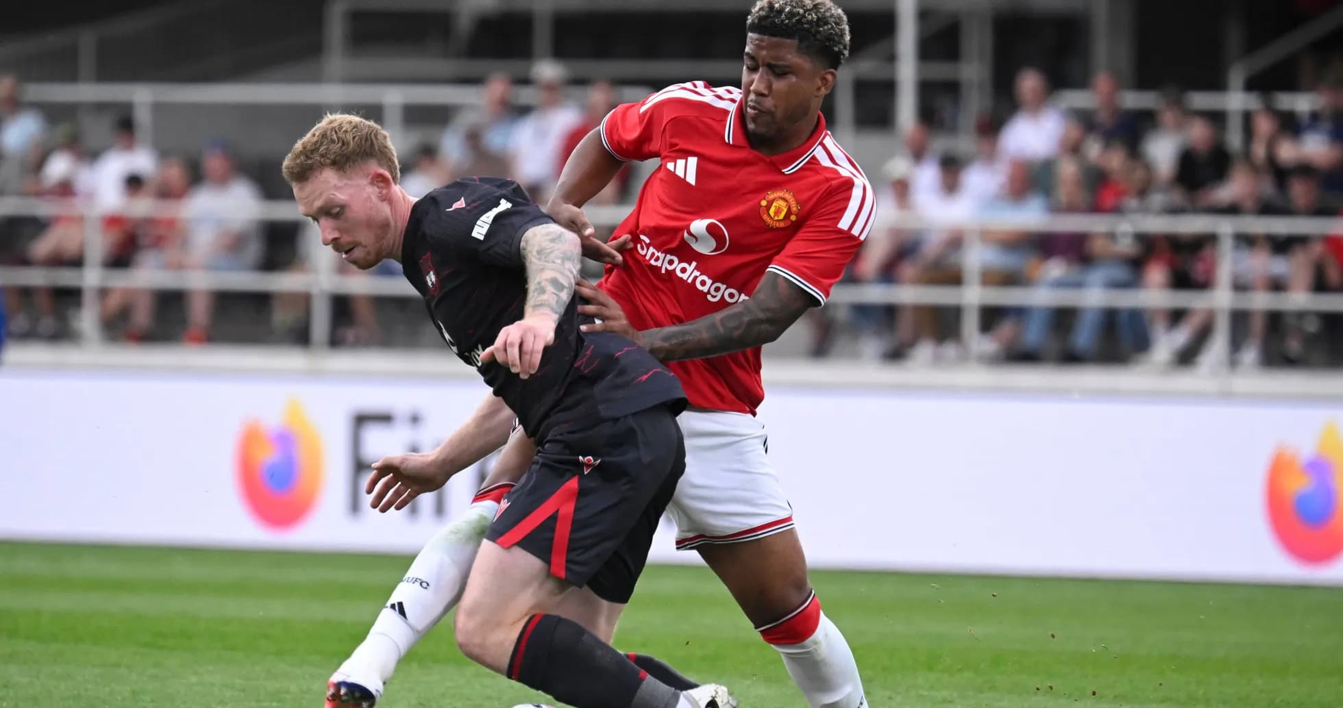 Player tackling opponent during football match Player tackling opponent during football match