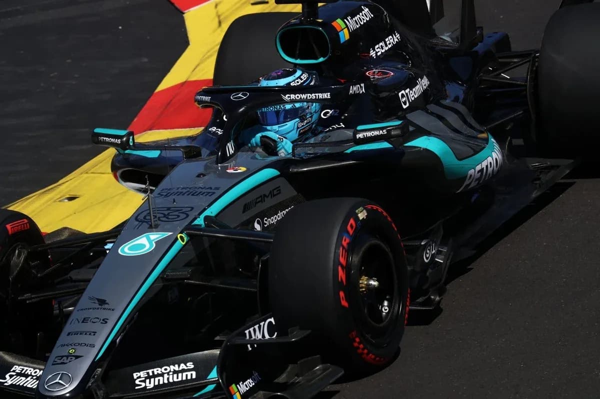 Mercedes F1 car navigating a corner on track Mercedes F1 car navigating a corner on track