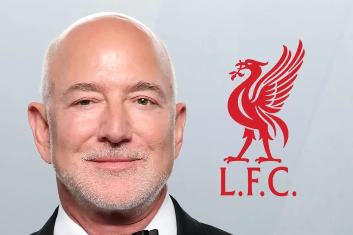 Man smiling next to Liverpool FC logo Man smiling next to Liverpool FC logo