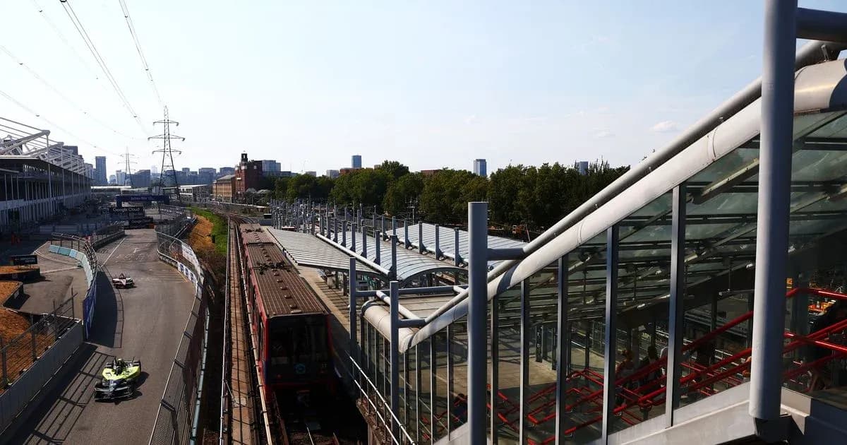 Formula E car racing near train station in city Formula E car racing near train station in city