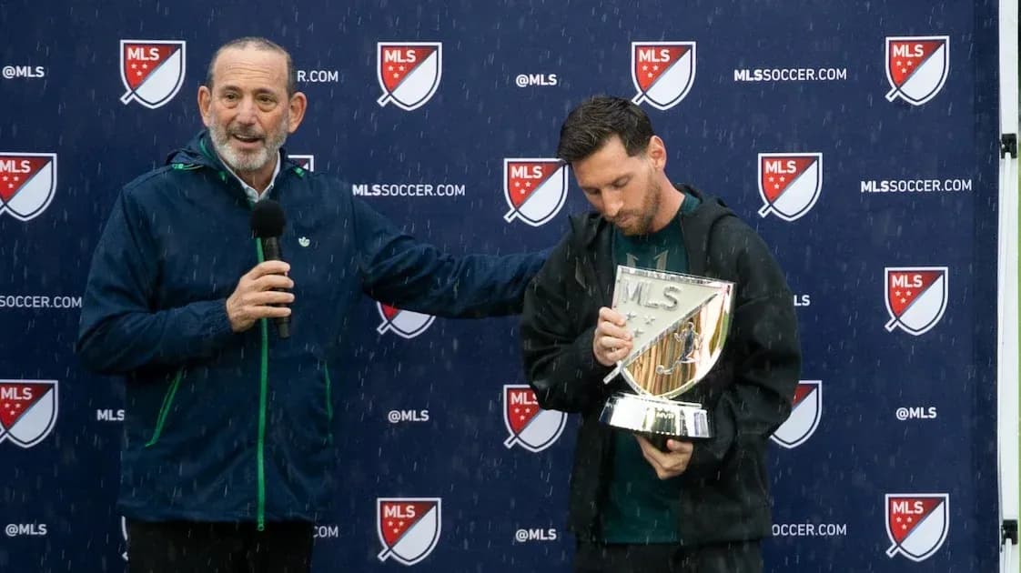 Lionel Messi holding MLS trophy during press event Lionel Messi holding MLS trophy during press event