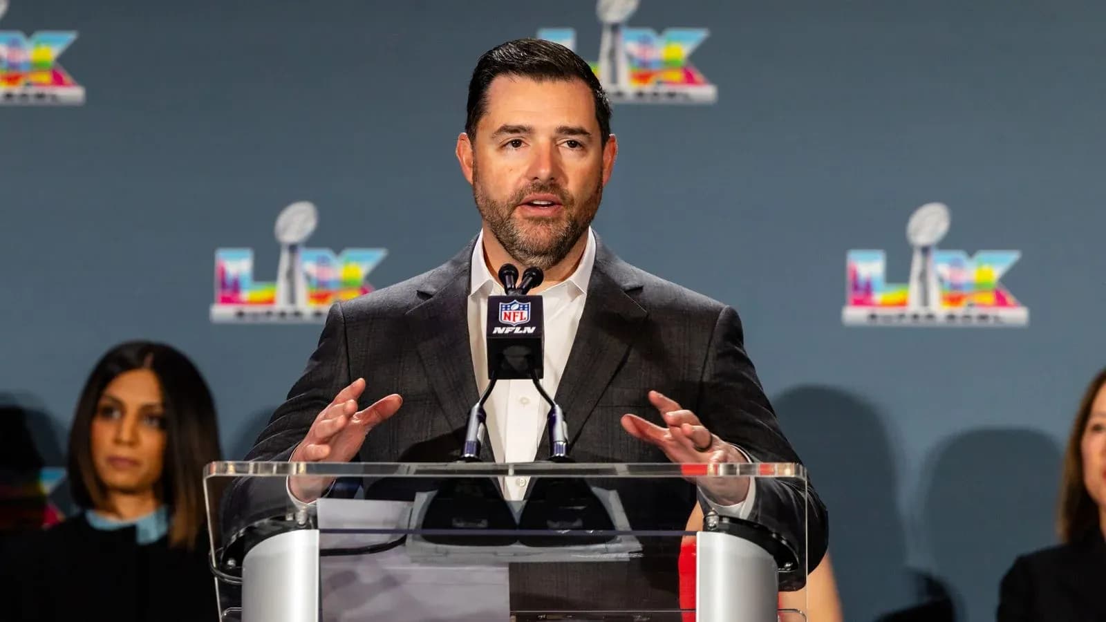 Spokesperson speaking at NFL press conference podium Spokesperson speaking at NFL press conference podium