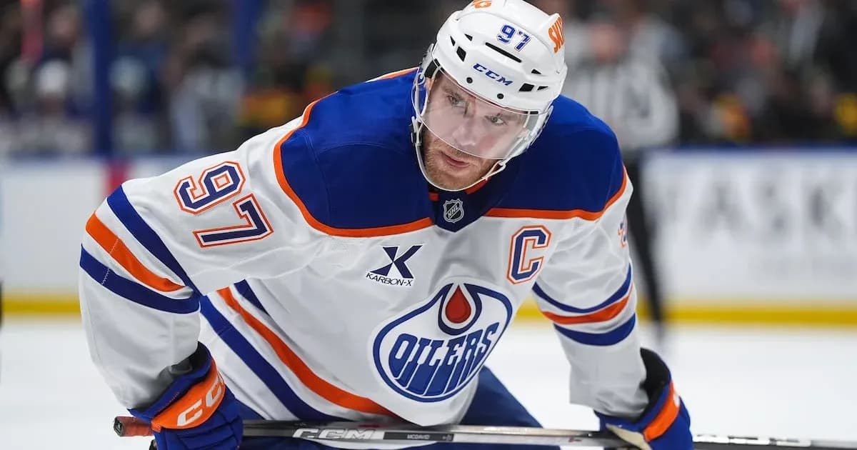 Hockey player wearing Oilers jersey on the ice Hockey player wearing Oilers jersey on the ice
