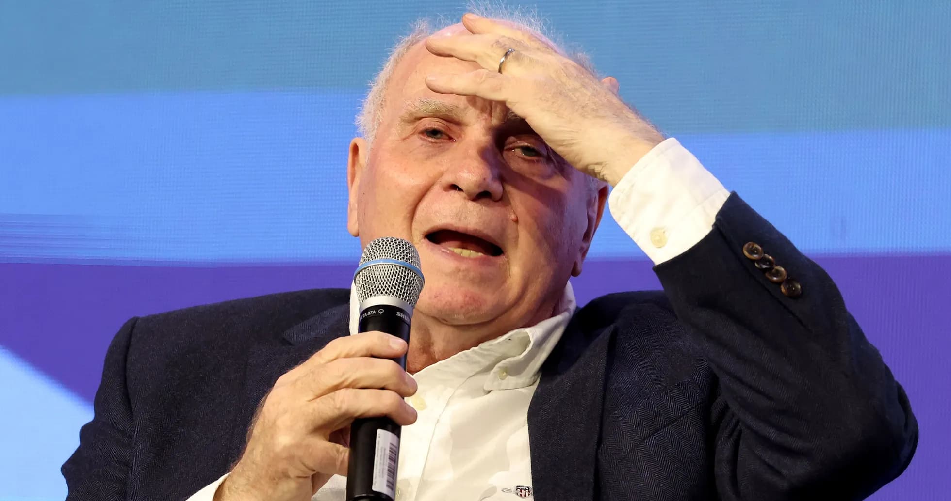 Speaker holding microphone during a discussion event Speaker holding microphone during a discussion event