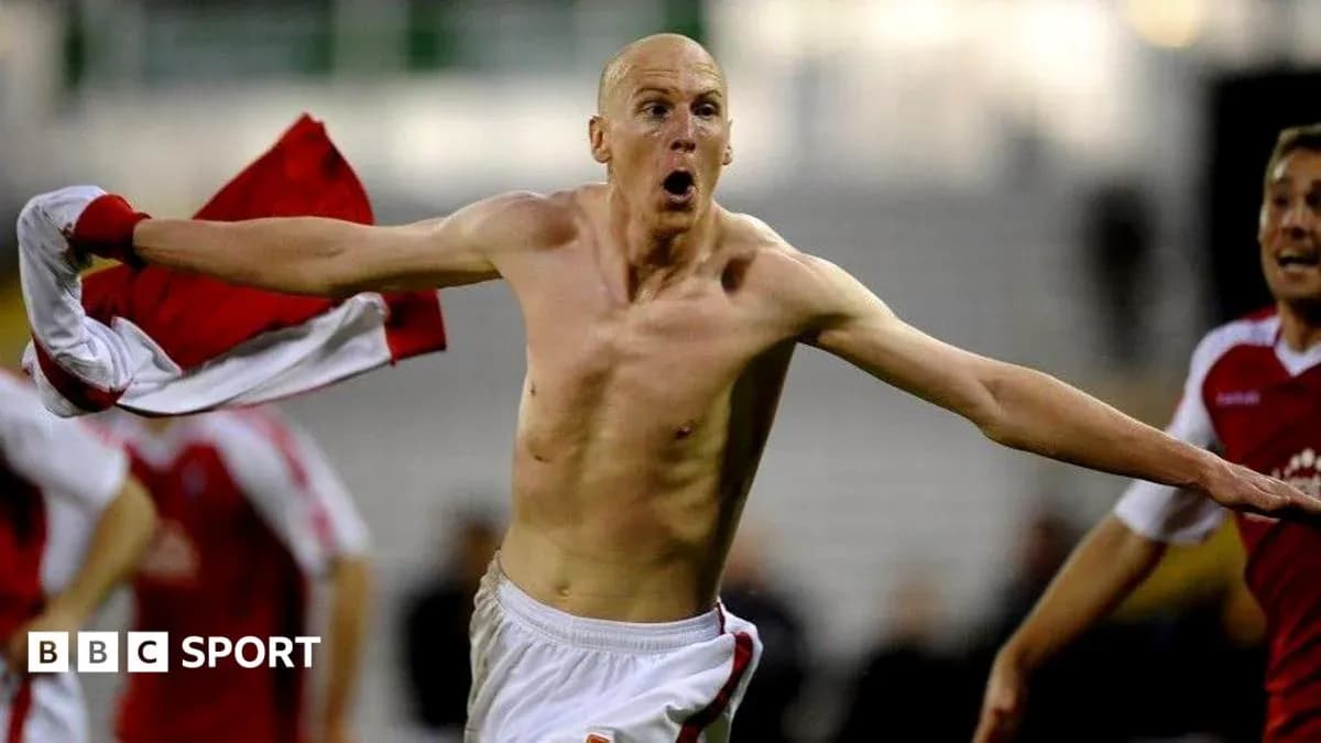 Player celebrating with shirt after scoring goal Player celebrating with shirt after scoring goal