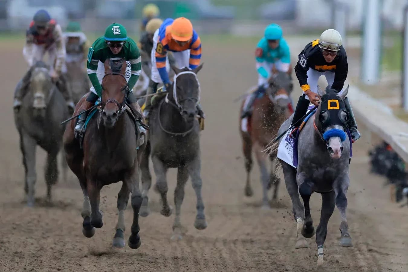 Jockeys racing on horses during horse race Jockeys racing on horses during horse race