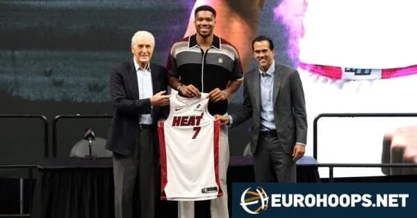 Player holding Miami Heat jersey with team officials Player holding Miami Heat jersey with team officials