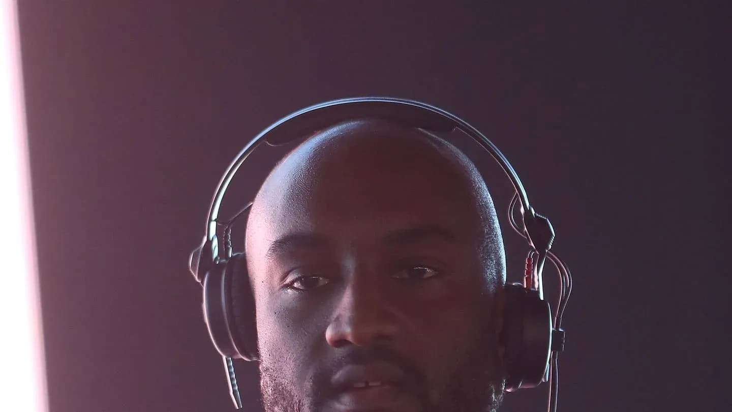 Man wearing headphones in a dimly lit setting Man wearing headphones in a dimly lit setting