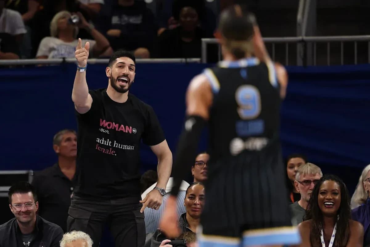 Fan cheering during basketball game with players visible Fan cheering during basketball game with players visible