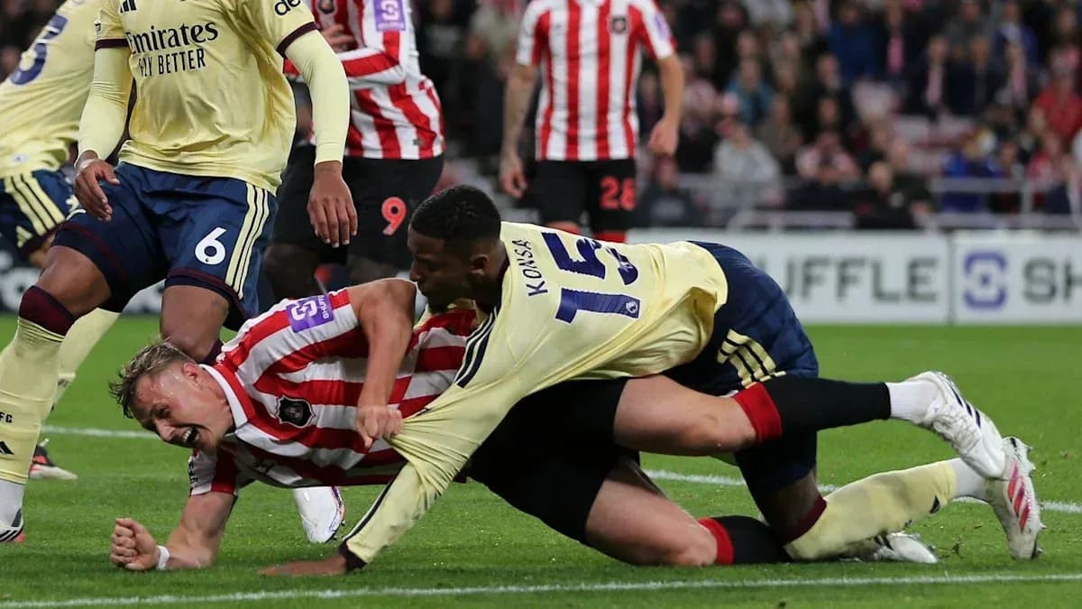 Player tackling opponent on the football pitch Player tackling opponent on the football pitch