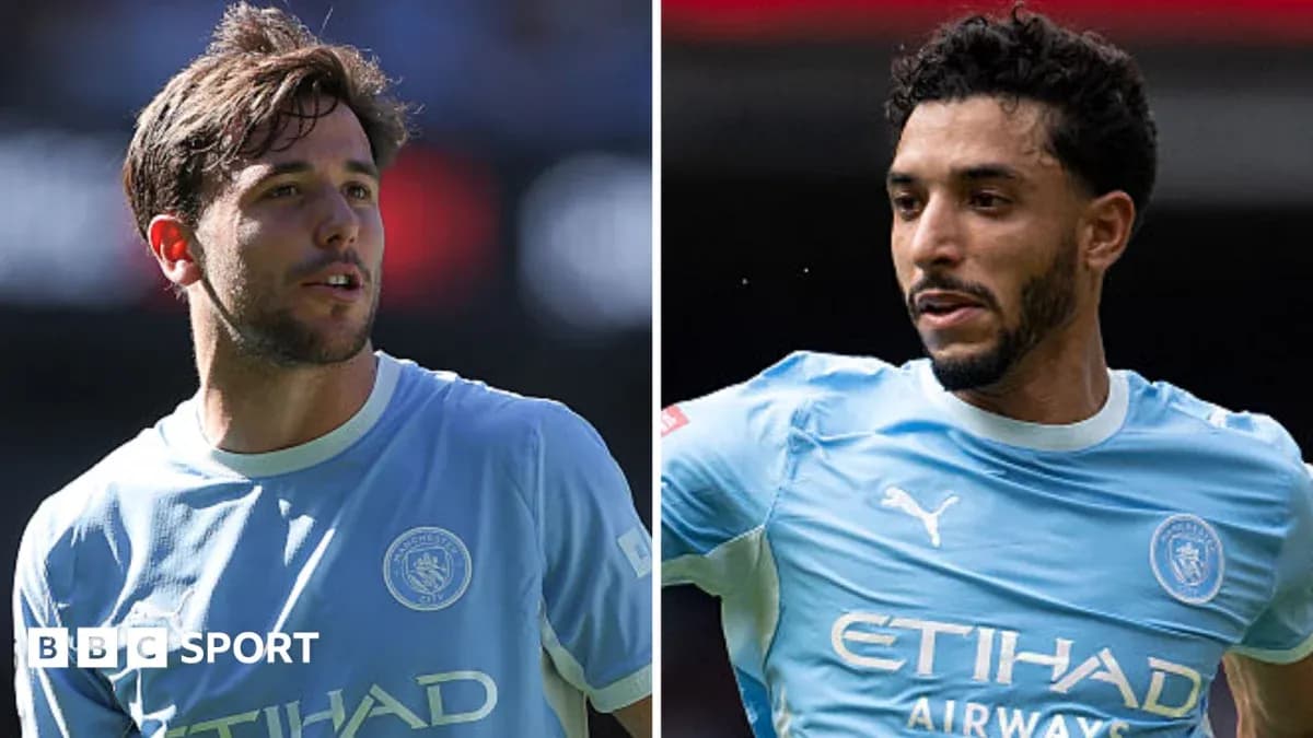 Two Manchester City players in training jerseys Two Manchester City players in training jerseys
