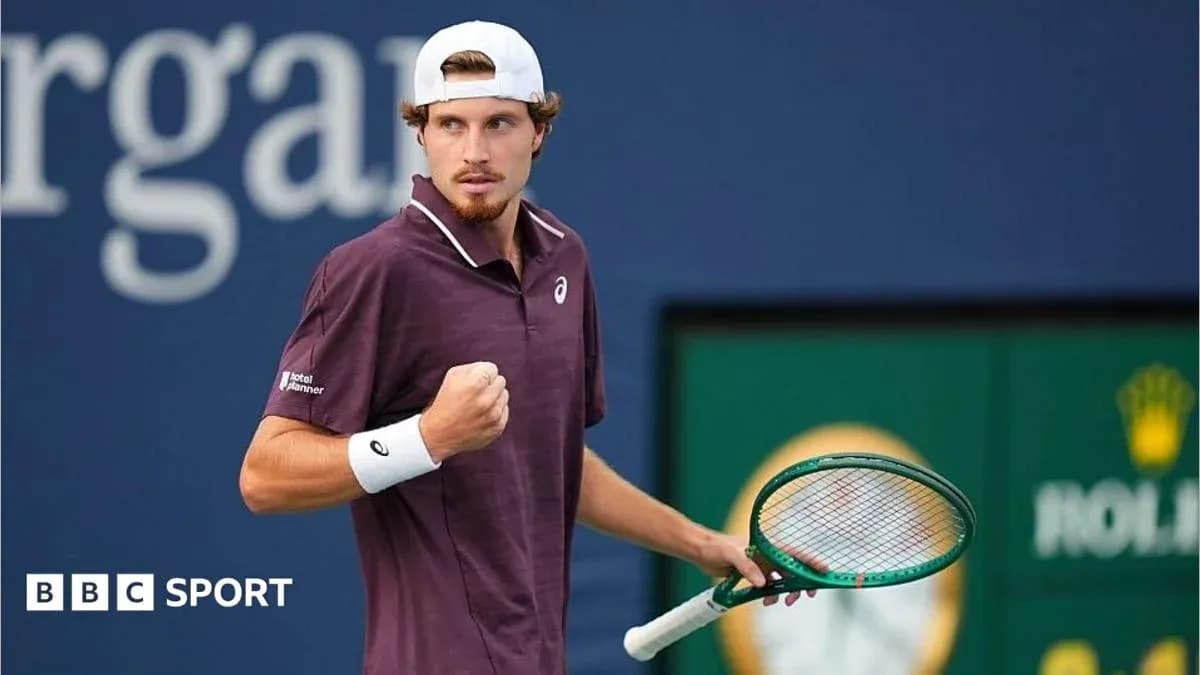 Tennis player celebrating with racket on court Tennis player celebrating with racket on court