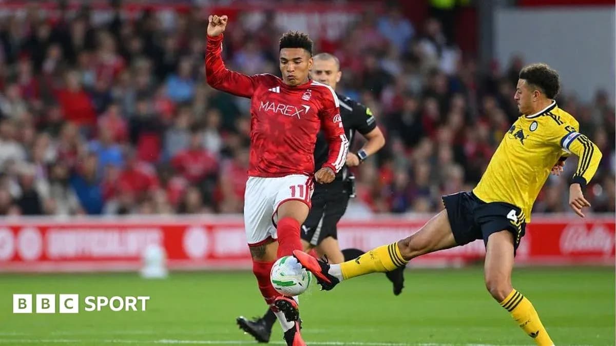 Player kicking ball during football match action Player kicking ball during football match action