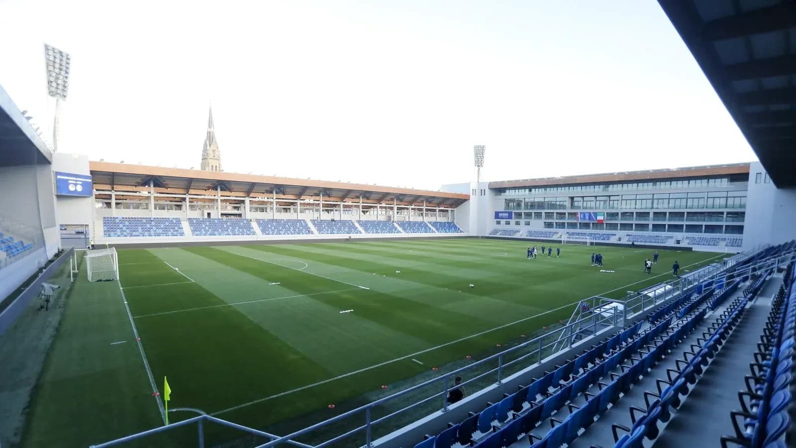 Stadium field with players training before match Stadium field with players training before match