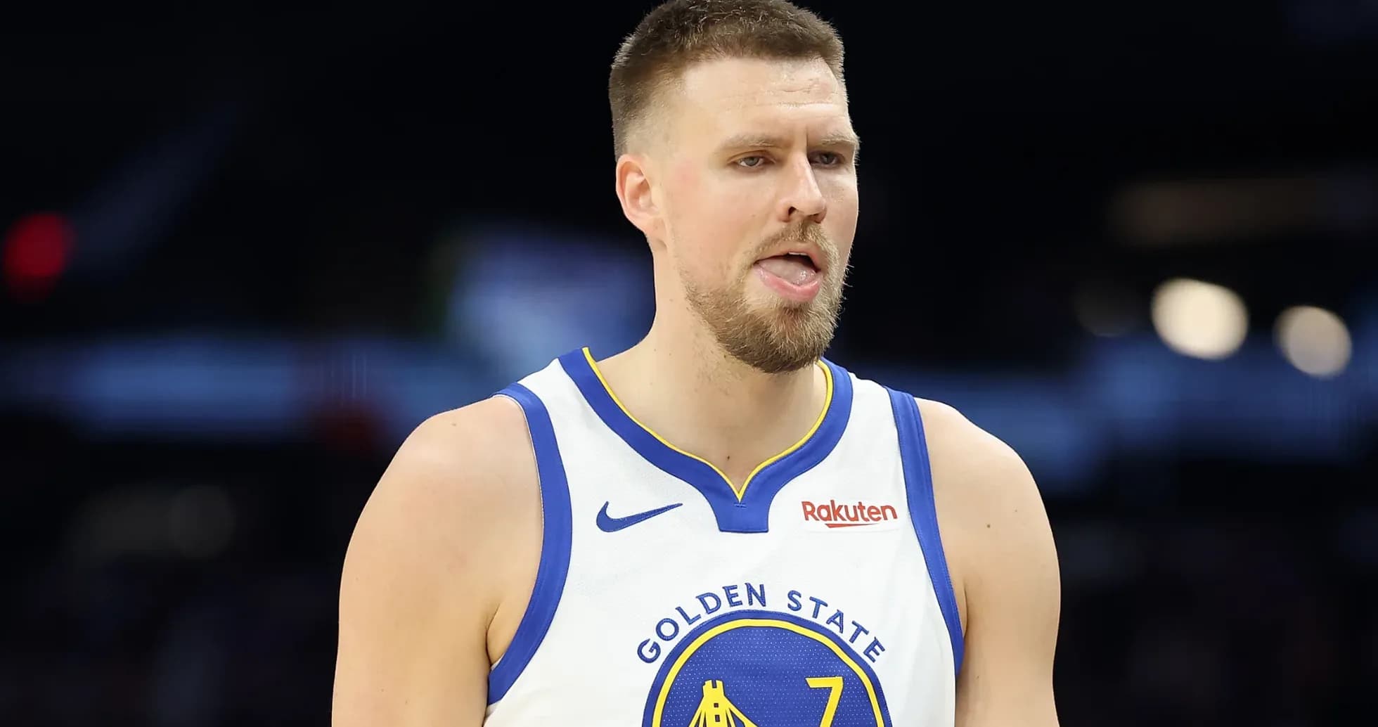 Basketball player in Golden State jersey on court Basketball player in Golden State jersey on court