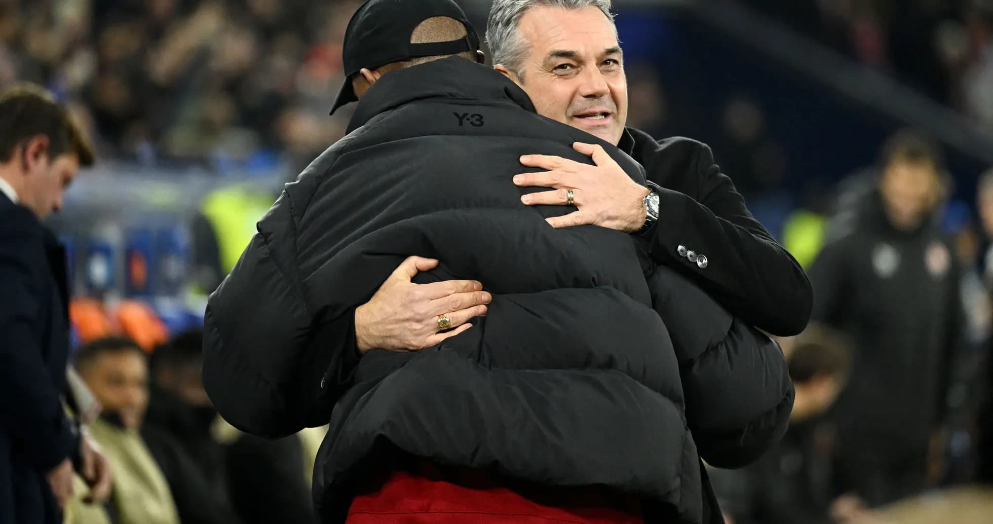 Trainers embracing on the sidelines after match Trainers embracing on the sidelines after match