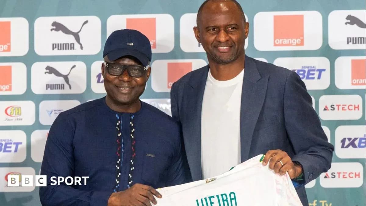 Two men holding a football shirt at event Two men holding a football shirt at event