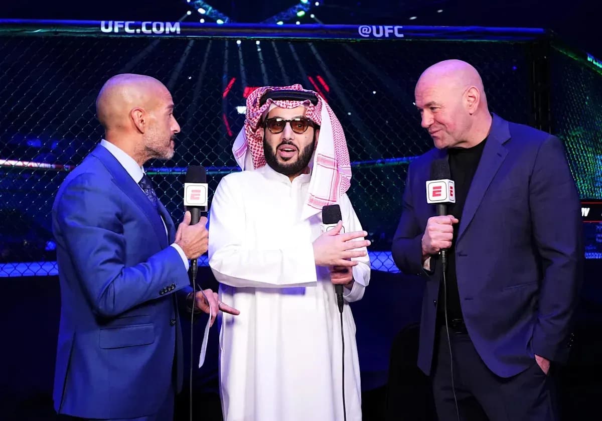 Three men speaking at UFC event with microphones Three men speaking at UFC event with microphones