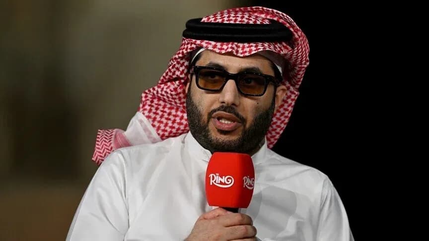 Shiekh speaking into microphone at event Shiekh speaking into microphone at event
