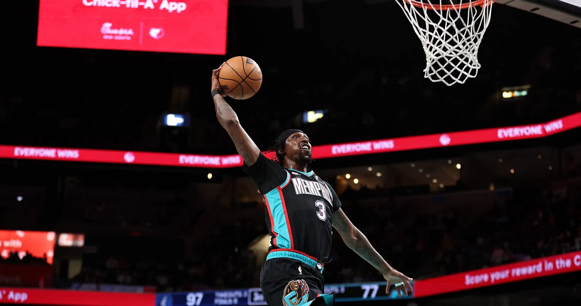 Basketball player dunking during a game Basketball player dunking during a game