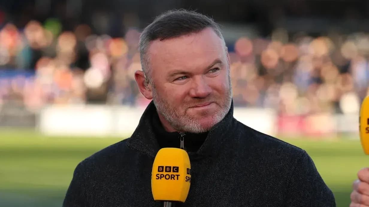 Analyst speaking into microphone during sports broadcast Analyst speaking into microphone during sports broadcast